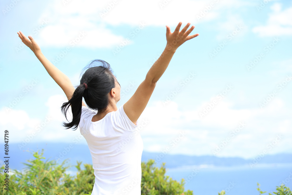 cheering woman hiker open arms at seaside mountain peak cheering woman hiker open arms at seaside mountain peak