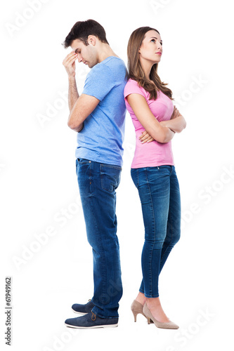 Unhappy couple standing back to back