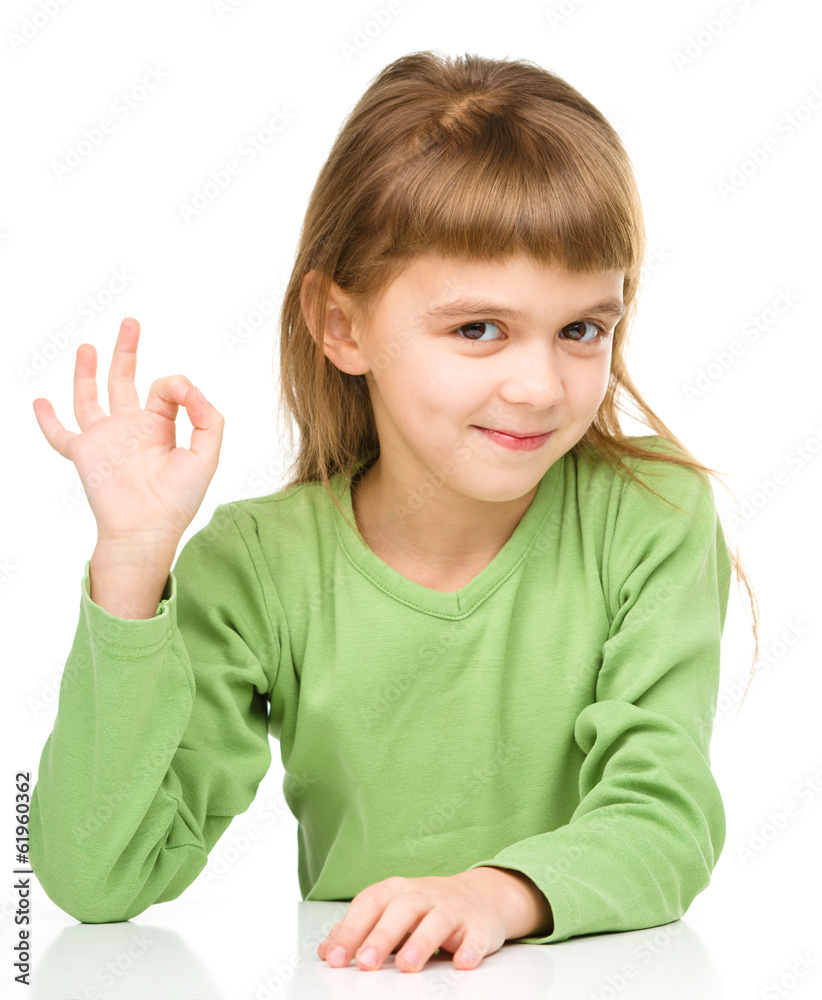 Happy little girl is showing OK sign Happy little girl is showing OK sign