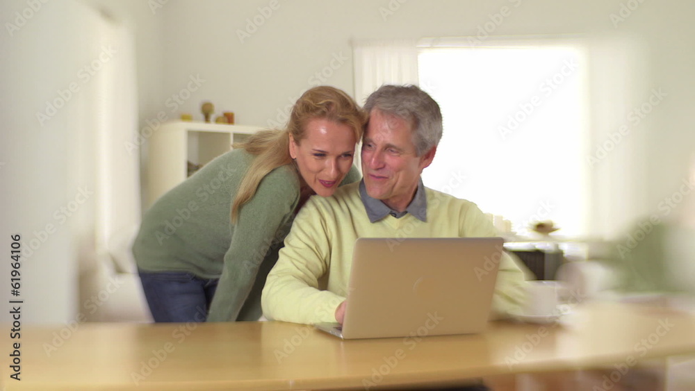 Happy senior couple using laptop Happy senior couple using laptop