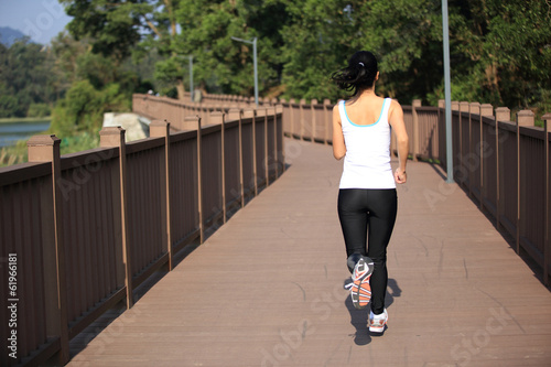 woman running on wooden deck 