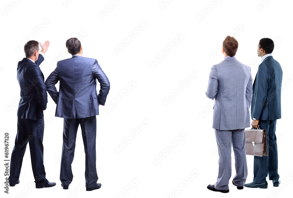 four business mans from the back - looking at something four business mans from the back - looking at something
