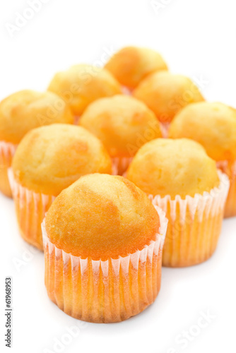golden cup cakes on a white background