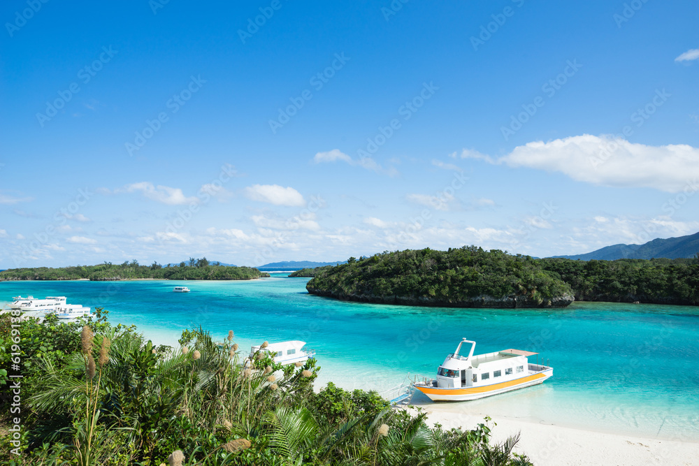 White sandy beach with clear blue lagoon water White sandy beach with clear blue lagoon water