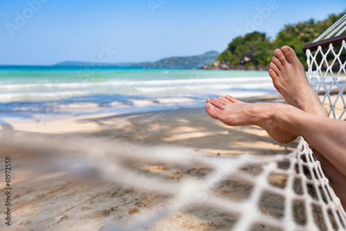 woman feet in hammock on the beach photo