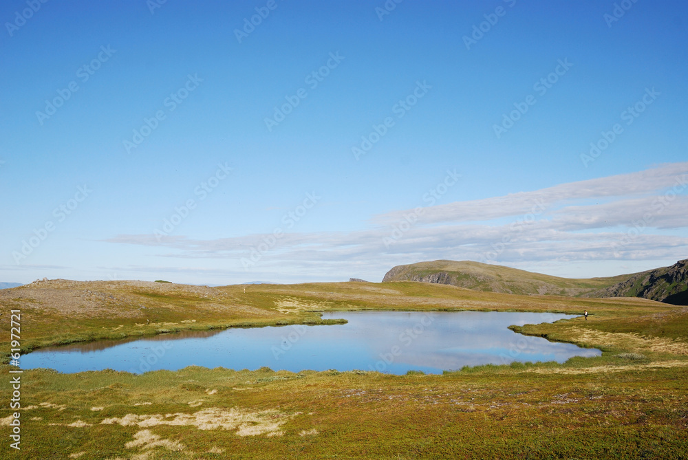 Blue lake on the green hill of Soroya