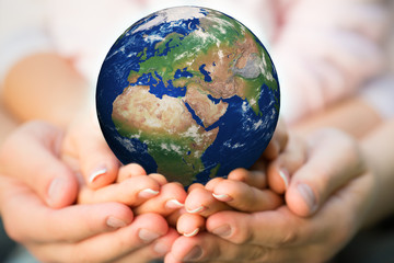 Family holding Earth planet