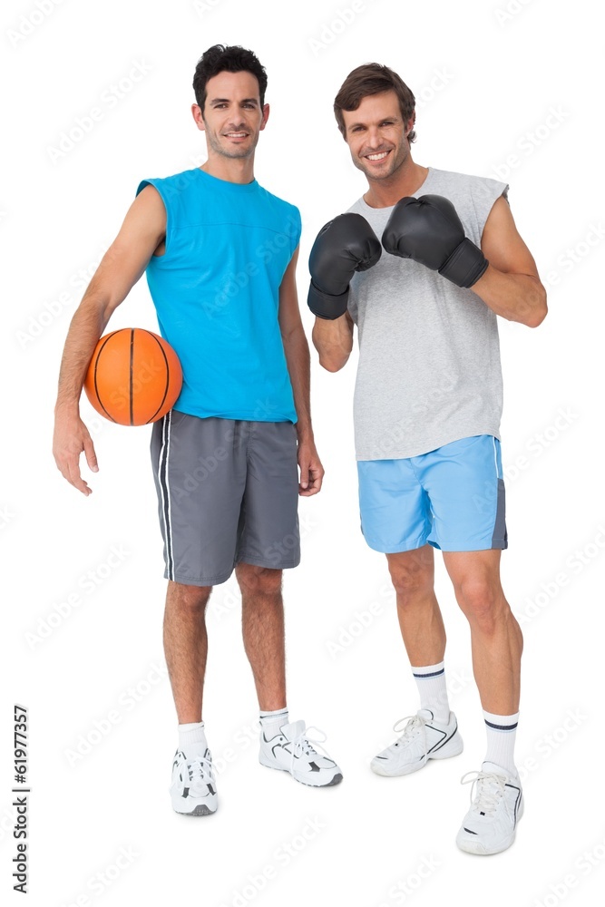 Two fit men with boxing gloves and basketball Two fit men with boxing gloves and basketball