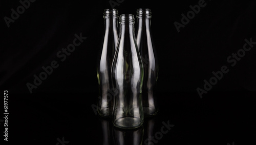 Empty bottles over black background