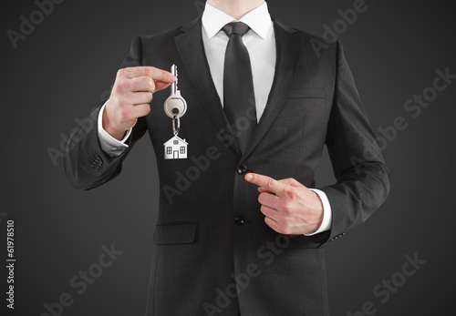 businessman giving a key