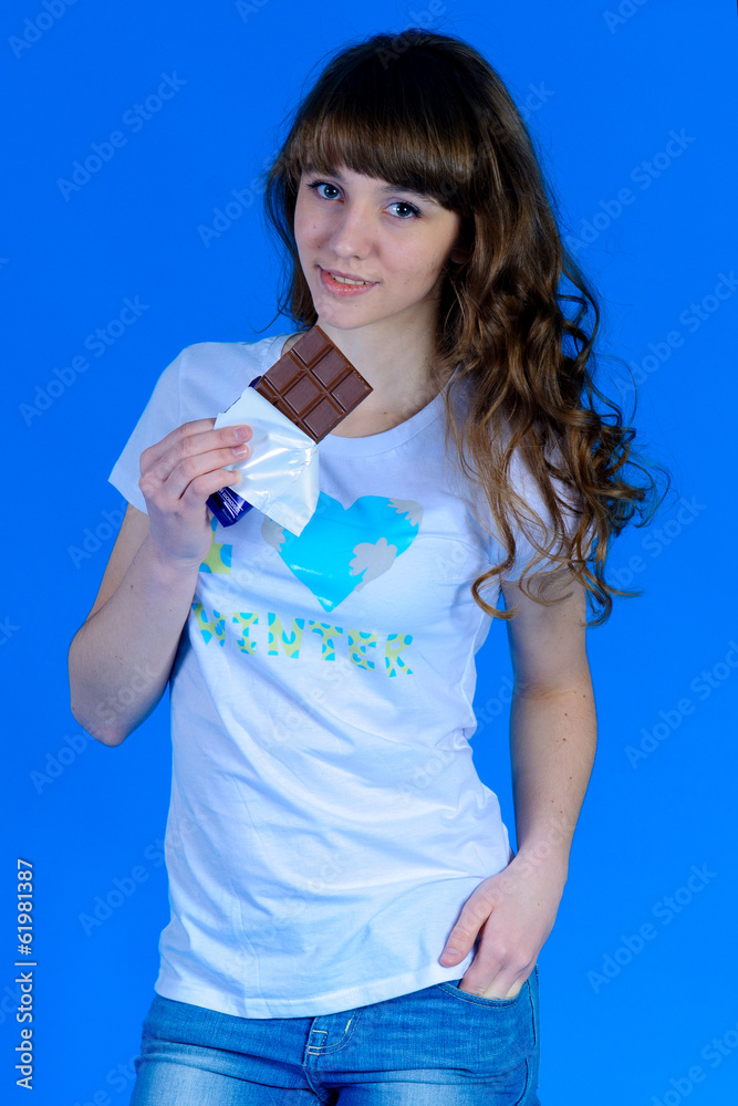 pretty girl posing in studio on a blue background pretty girl posing in studio on a blue background