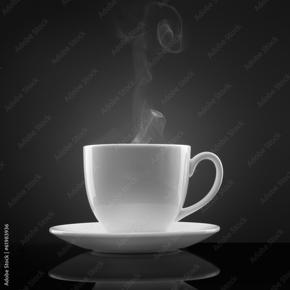 white cup with hot liquid and steam on black white cup with hot liquid and steam on black