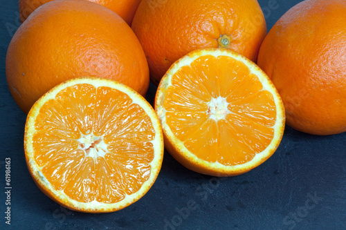 Orange coupée en deux sur fond d'ardoise