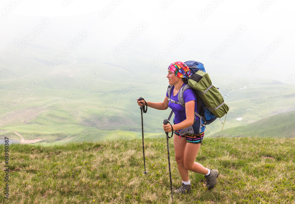 Young people are hiking in Carpathian mountains in summertime