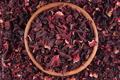 Dried petals of hibiscus in a wooden bowl © sss615