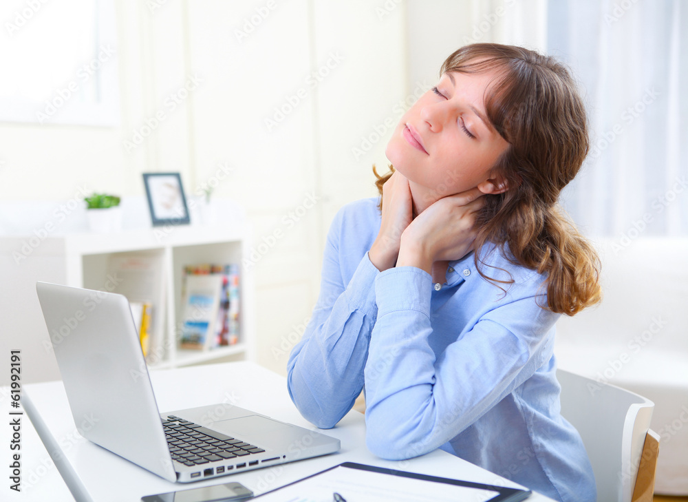 Portrait of young smiling business woman relaxing at work
