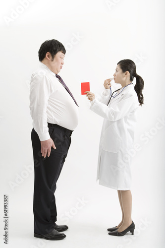 doctor taking out red card to obese male