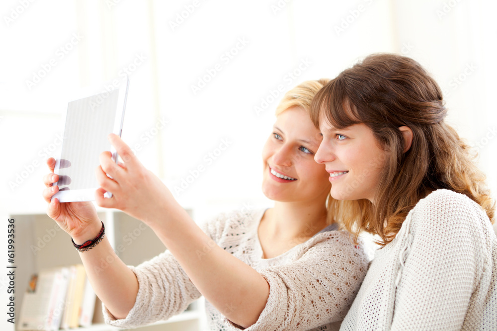 Girls on sofa taking selfie picture with tablet Girls on sofa taking selfie picture with tablet