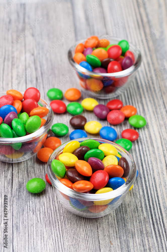 Three tiny bowls with crunchy color candies Three tiny bowls with crunchy color candies
