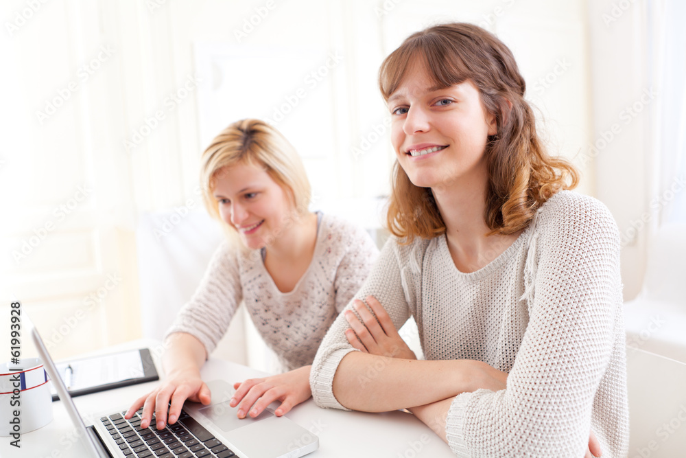 Two students girls working on a laptop Two students girls working on a laptop