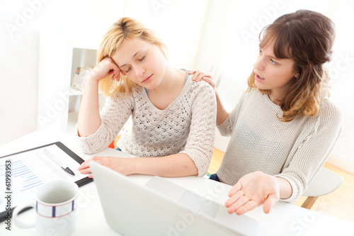 Girl sleeping instead of working with her friend