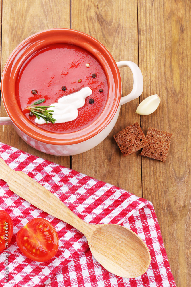 Tasty tomato soup on wooden table Tasty tomato soup on wooden table