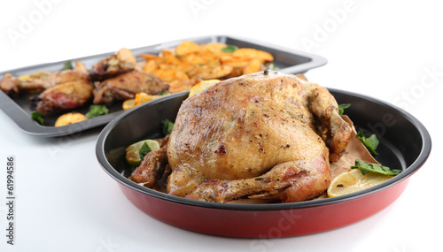 Woman holding pan with  homemade fried chicken  and vegetables