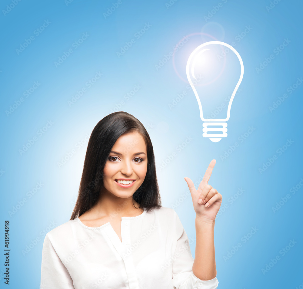 A successful and beautiful businesswoman with a bulb A successful and beautiful businesswoman with a bulb