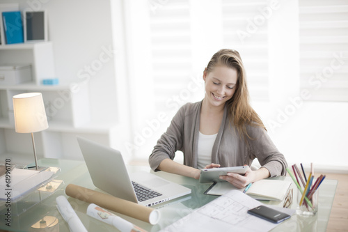 beautiful young woman on the workplace using a digital tablet