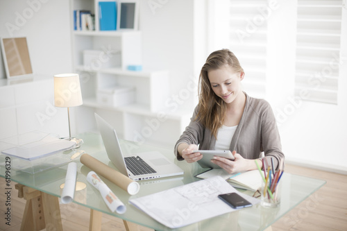 beautiful young woman on the workplace using a digital tablet