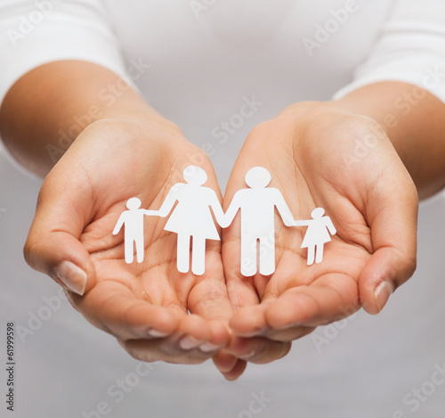 womans hands with paper man family photo