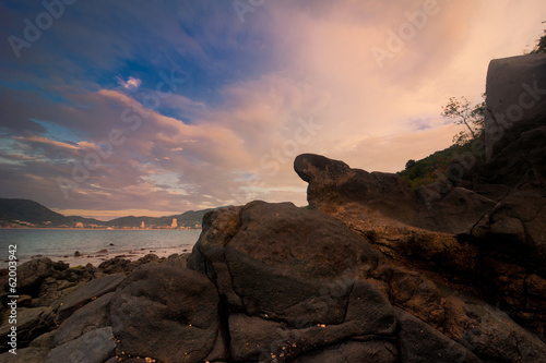 Sunset at tropical beach with rocks and stones