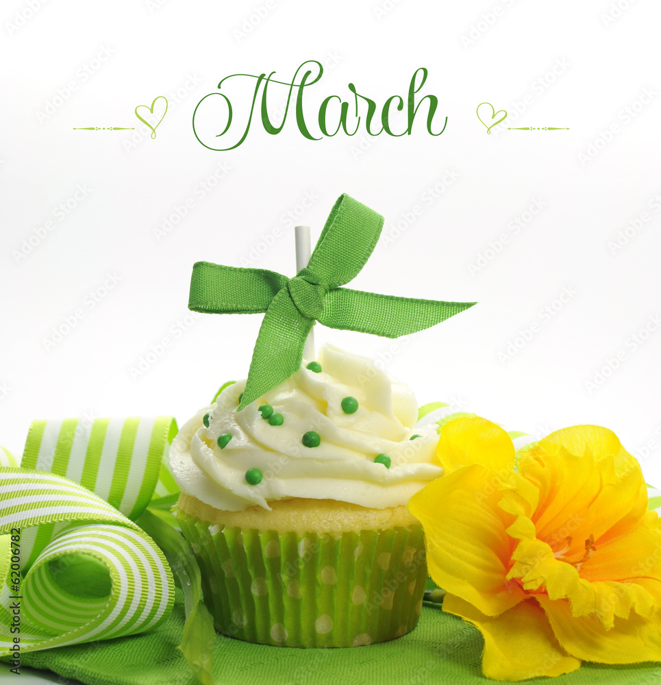 Fotografie Happy March Spring theme cupcake with green yellow decorations.
