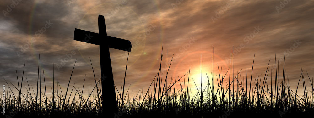 Black cross in grass at sunset - obrazy, fototapety, plakaty 