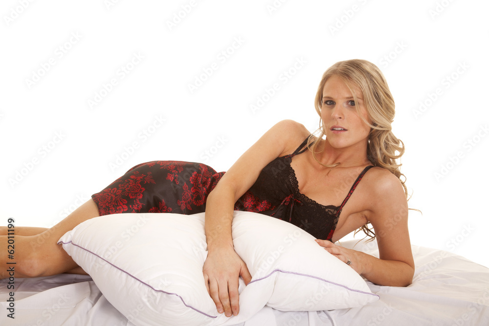 Woman black and red nightgown lay on side serious Woman black and red nightgown lay on side serious