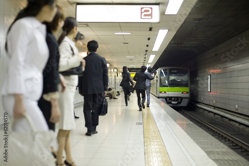 businessman running after train on the platform photo