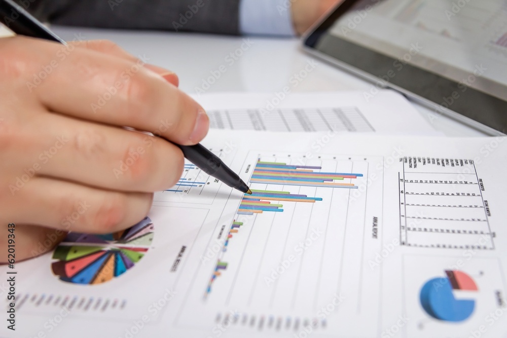 Businessman reviewing documents in digital tablet Businessman reviewing documents in digital tablet
