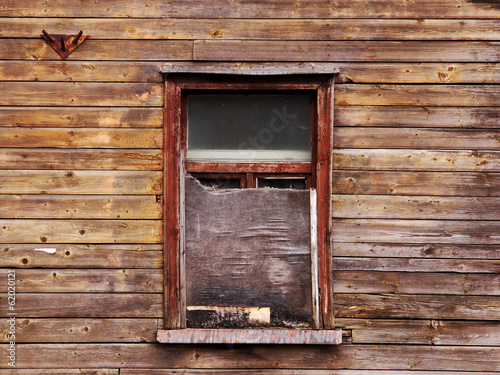 wooden wall with a board up window photo