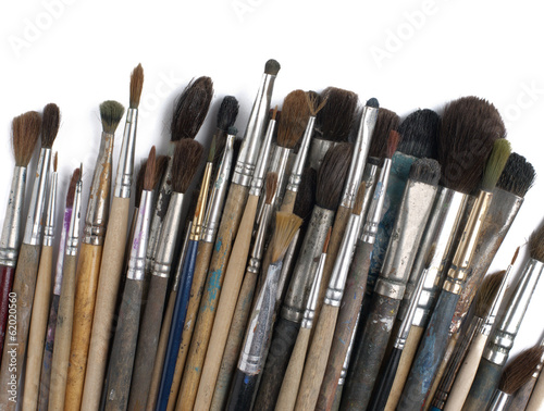 Assorted dirty old painting brushes. Isolated on white