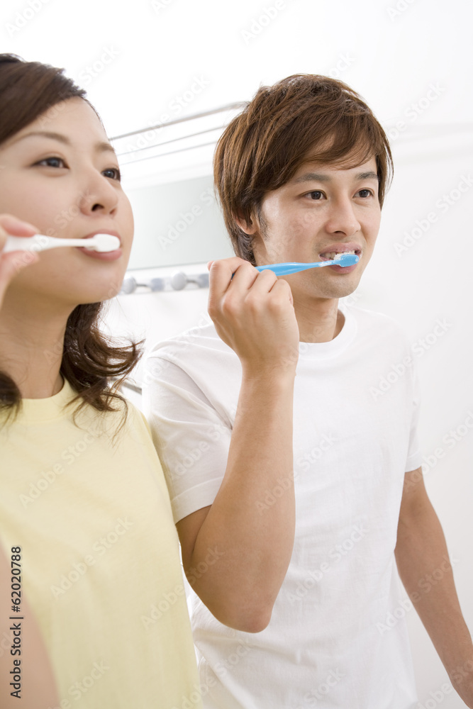 couple brushing their teeth couple brushing their teeth