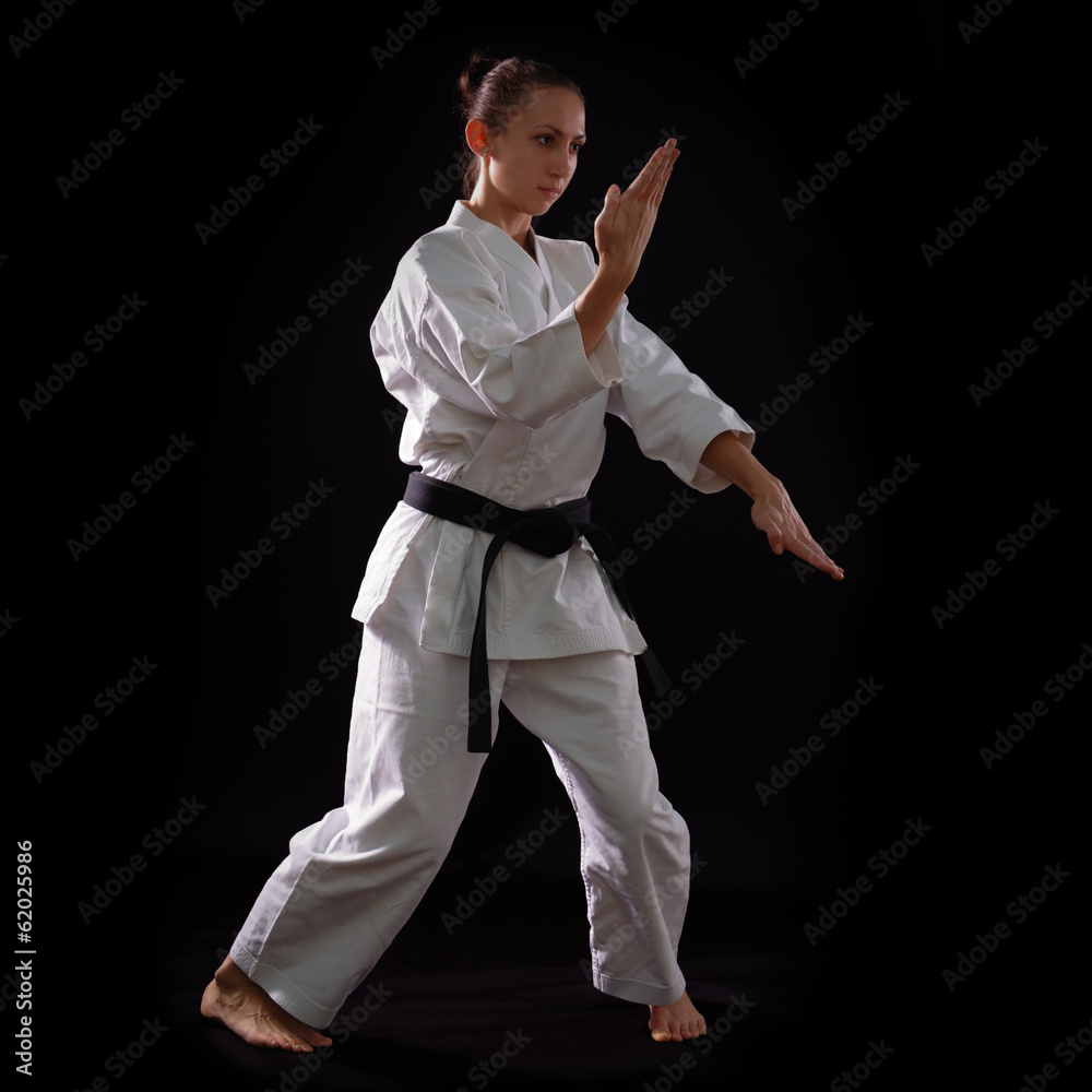 karate girl with black belt posing, champion of the world, on bl