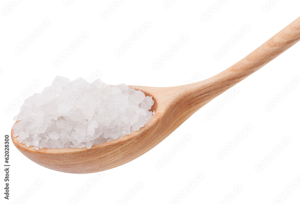Mineral salt in wooden spoon isolated on white background cutout Mineral salt in wooden spoon isolated on white background cutout