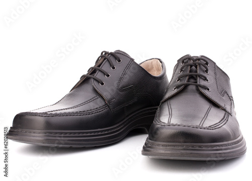 Black glossy man’s shoes with shoelaces
