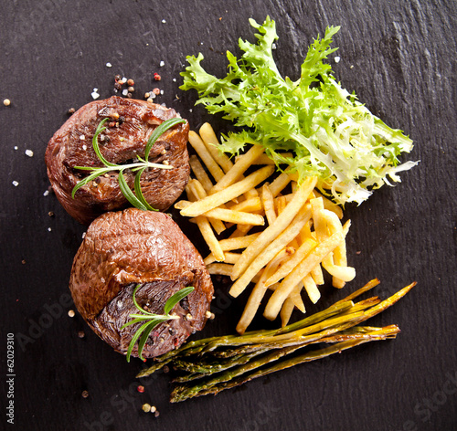 Fresh beef steak on black stone photo