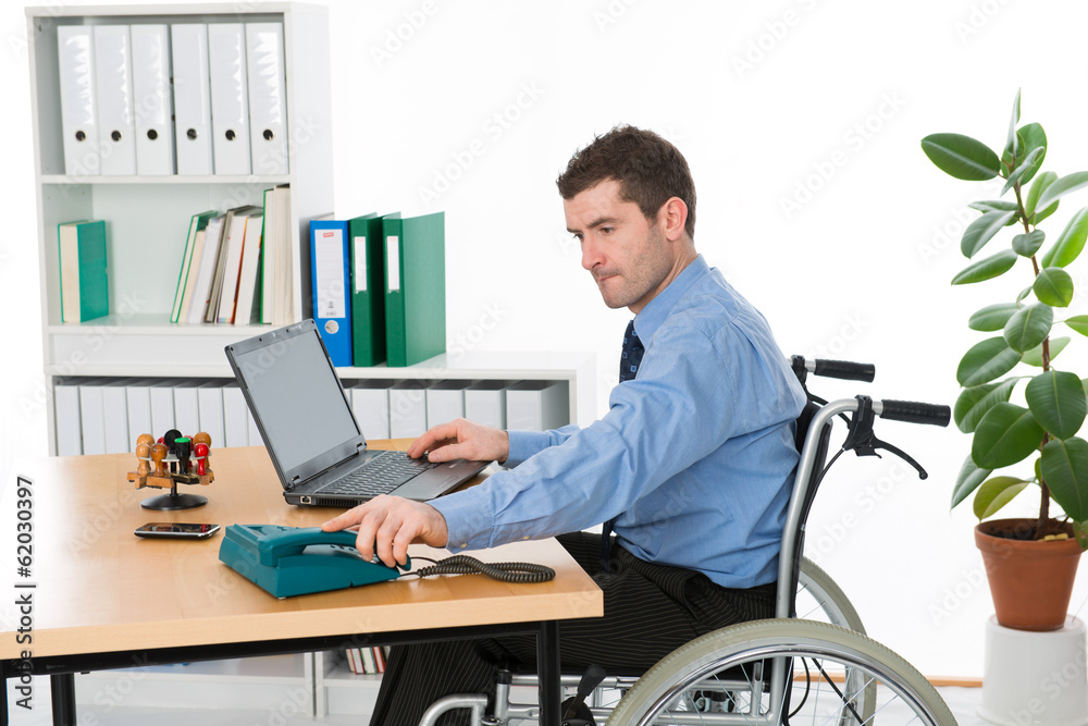 man in wheelchair on workplace man in wheelchair on workplace