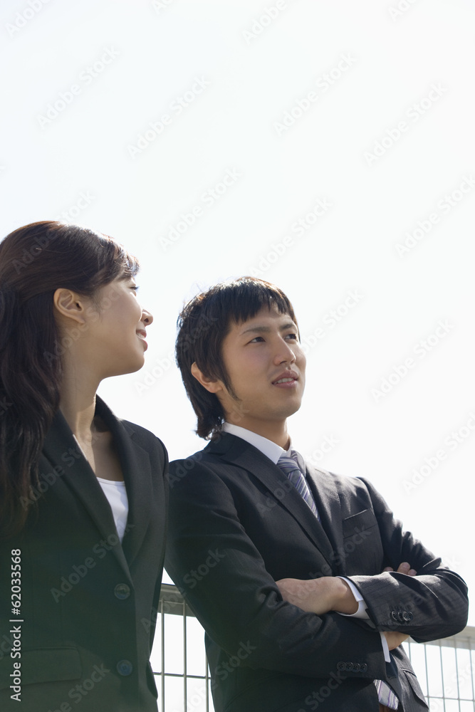 man and woman talking in front of fence man and woman talking in front of fence