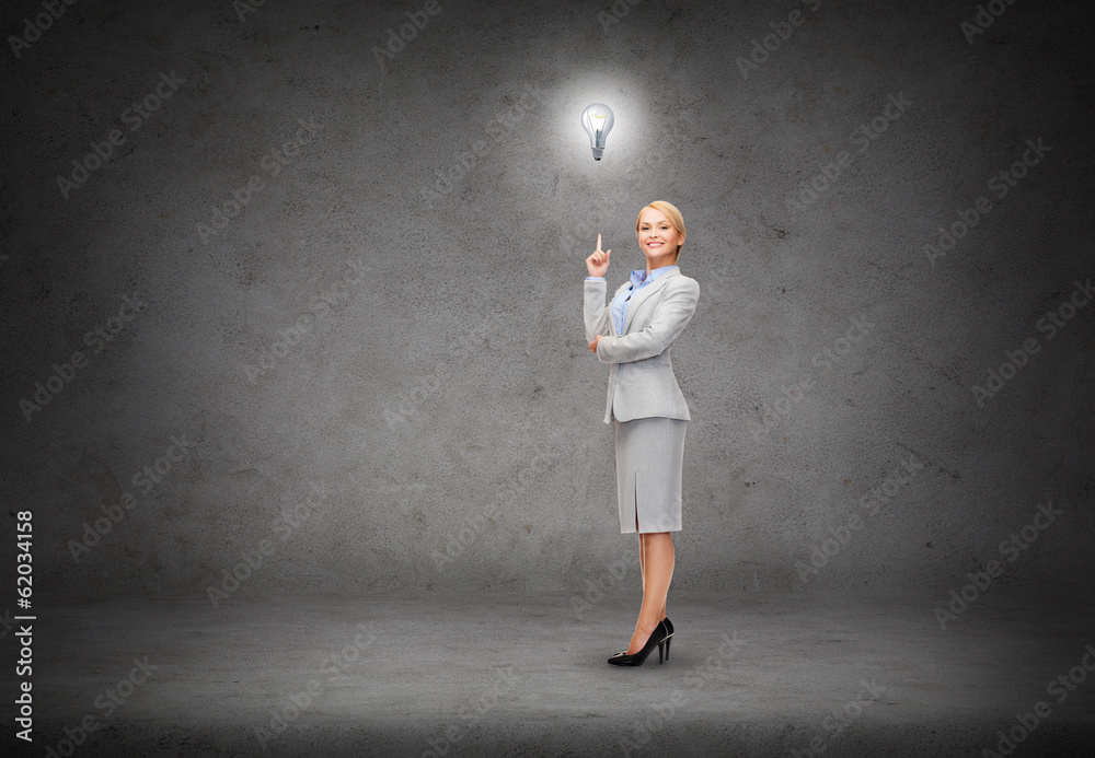 attractive young businesswoman with her finger up attractive young businesswoman with her finger up