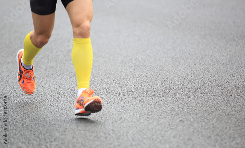 marathon athletes legs running on street 