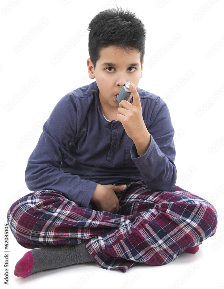 Little child wearing pajamas using asthma inhaler Little child wearing pajamas using asthma inhaler
