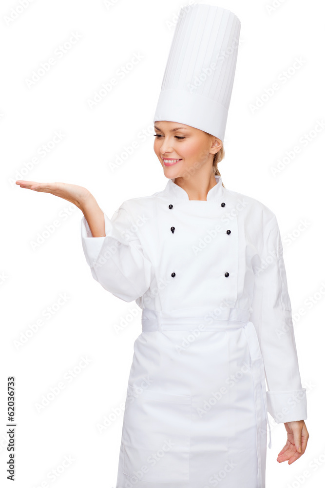 smiling female chef holding something on hand smiling female chef holding something on hand